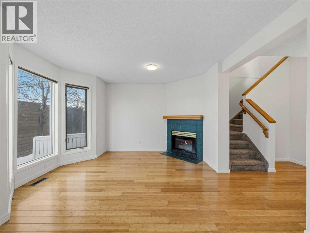 626 Hawkstone Manor Nw, Calgary, AB - Indoor Photo Showing Living Room With Fireplace