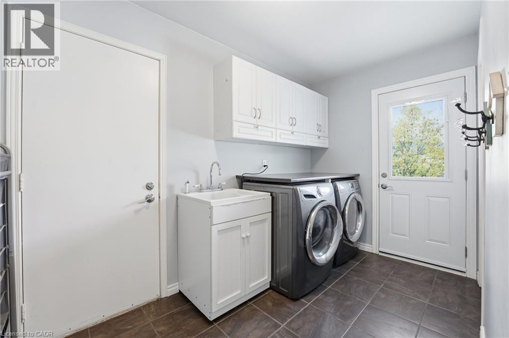 Main level laundry room/mudroom combination with garage access and side door to side yard - 84 Chatterson Drive, Ancaster, ON - Indoor Photo Showing Laundry Room