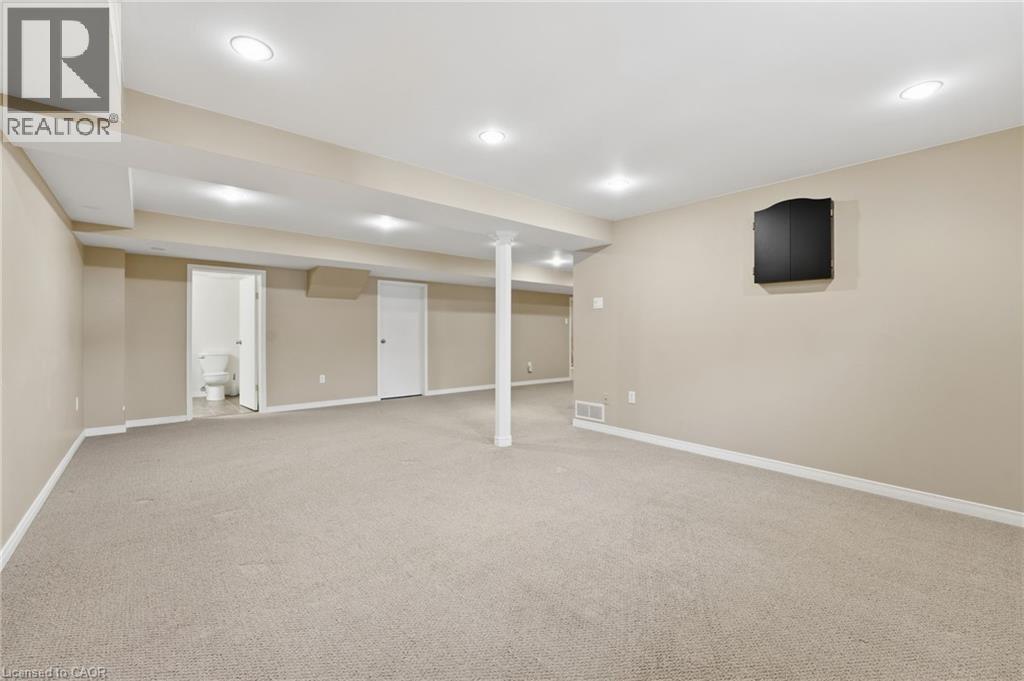 Basement open recreation space with view to storage room and basement bathroom - 84 Chatterson Drive, Ancaster, ON - Indoor Photo Showing Basement