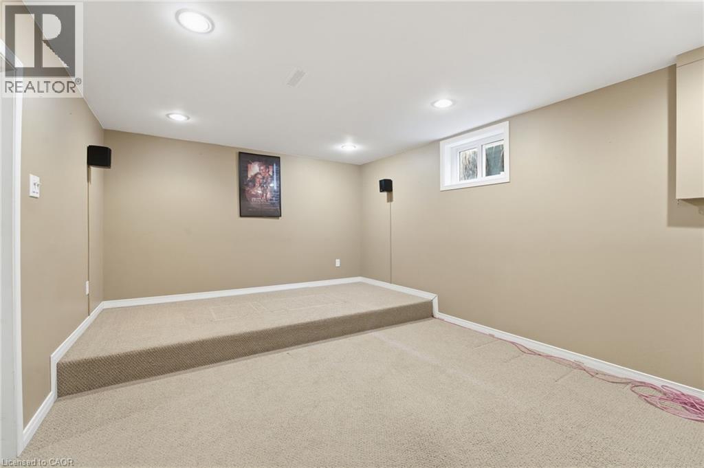 Basement media room with tiered/platform seating - 84 Chatterson Drive, Ancaster, ON - Indoor