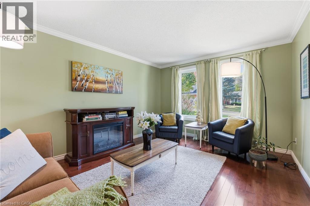 Front living room with view to street and hardwood flooring - 84 Chatterson Drive, Ancaster, ON - Indoor Photo Showing Living Room With Fireplace
