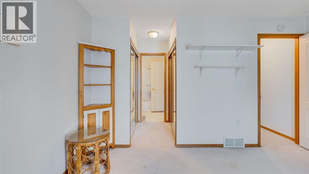 Primary has direct access to main bathroom - 42, 105 Elm Place, Okotoks, AB - Indoor Photo Showing Other Room