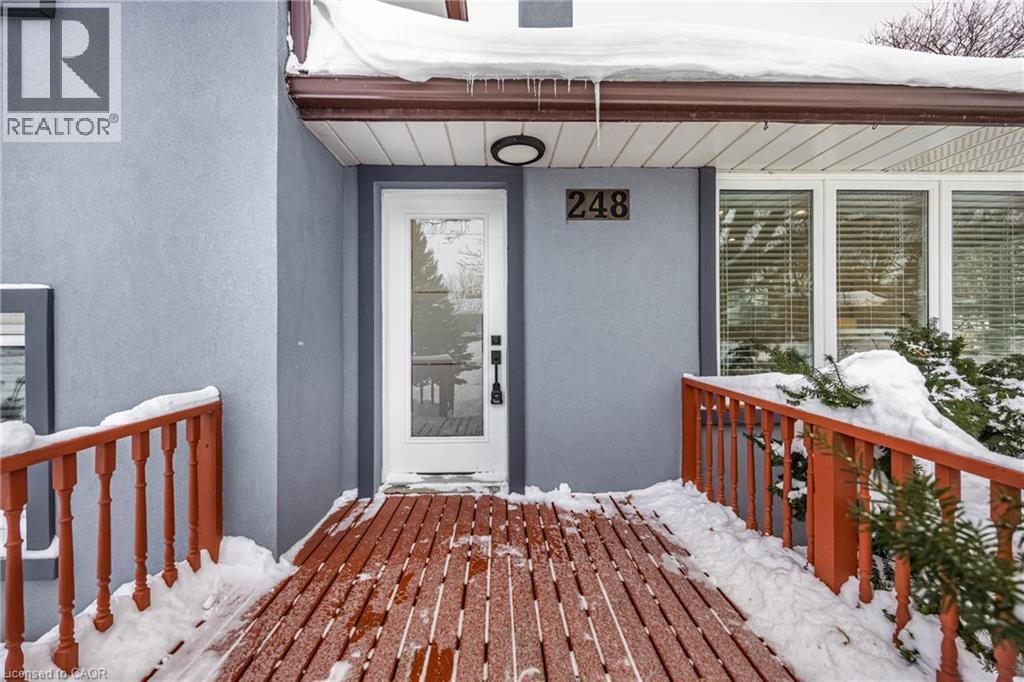 Snow covered property entrance with stucco siding and a deck - 248 Wales Crescent, Oakville, ON - Outdoor With Exterior