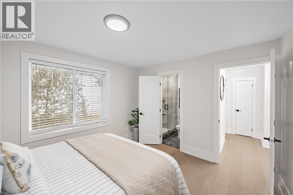 Bedroom with light wood-type flooring and ensuite bathroom - 248 Wales Crescent, Oakville, ON - Indoor Photo Showing Bedroom