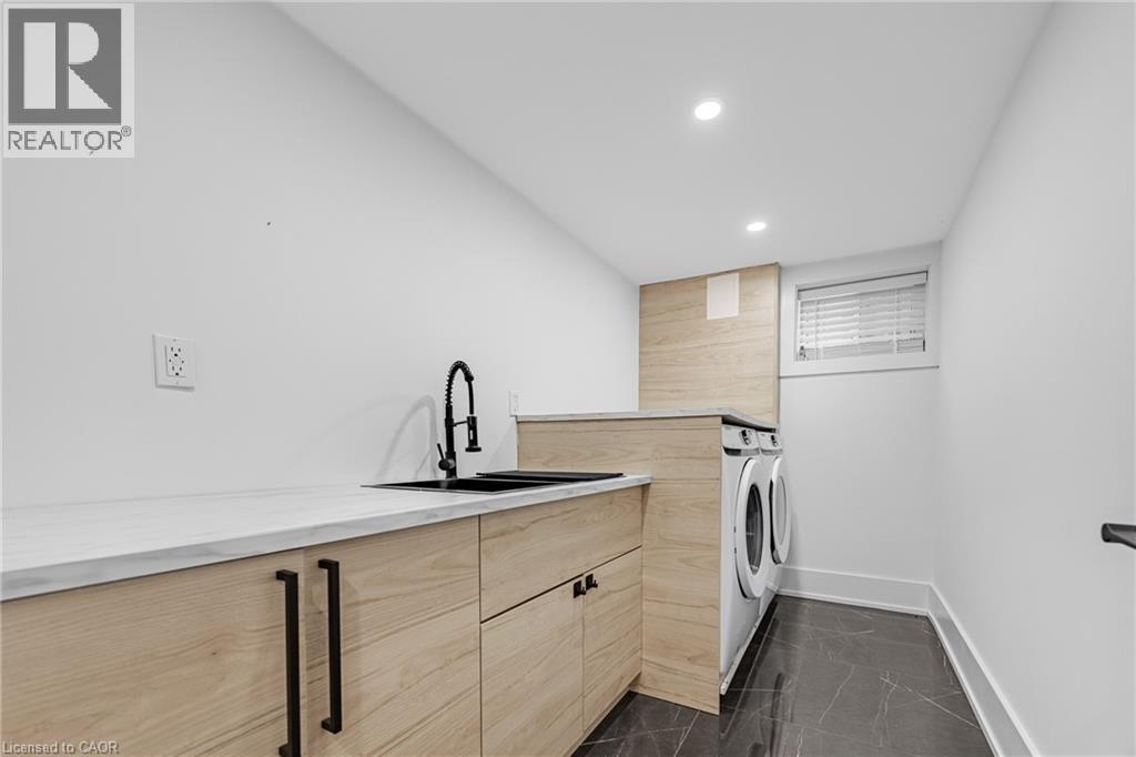 Laundry room featuring cabinet space, recessed lighting, and separate washer and dryer - 248 Wales Crescent, Oakville, ON - Indoor Photo Showing Laundry Room