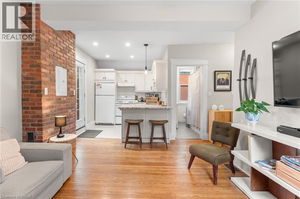 Living area featuring light wood-style flooring, recessed lighting, and electric panel - 58 Hohner Avenue, Kitchener, ON - Indoor Photo Showing Living Room