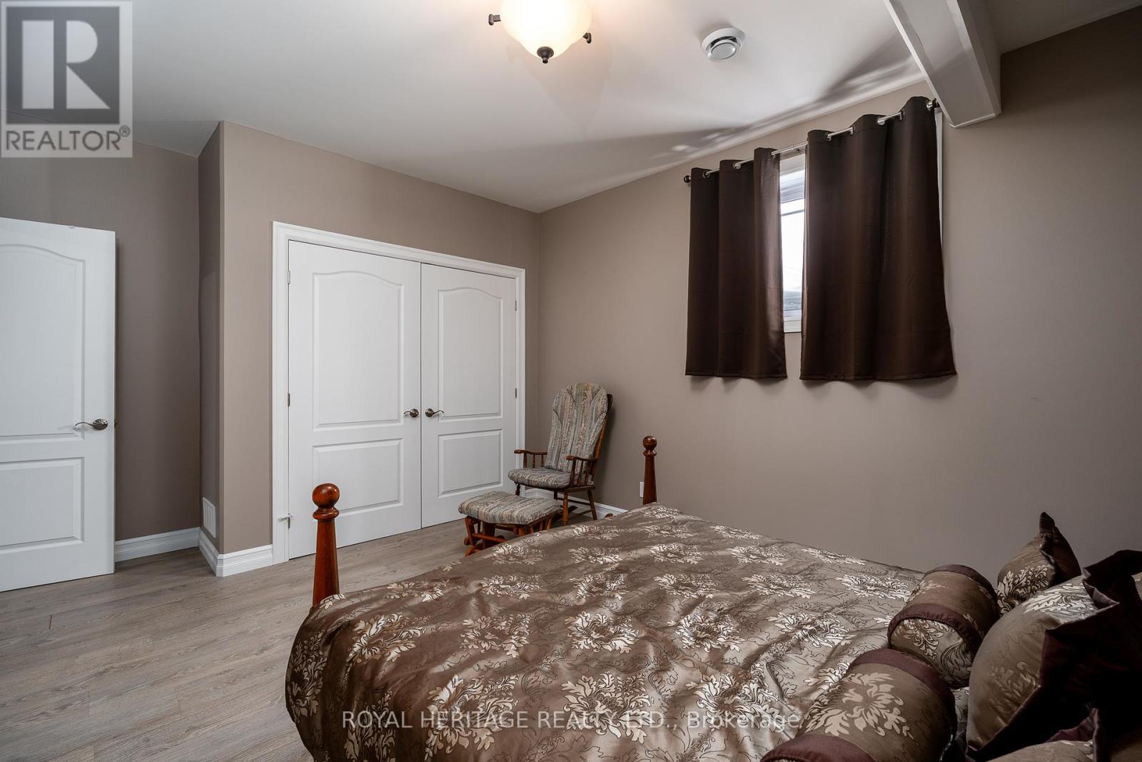 Lower Level Bedroom with Double Closet - 21564 Loyalist Parkway, Prince Edward County (Ameliasburg Ward), ON - Indoor Photo Showing Bedroom