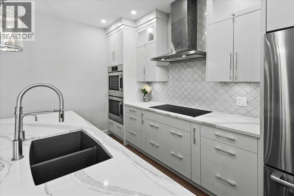Stylish renovated kitchen - 255 Gleneagles View, Cochrane, AB - Indoor Photo Showing Kitchen With Double Sink With Upgraded Kitchen