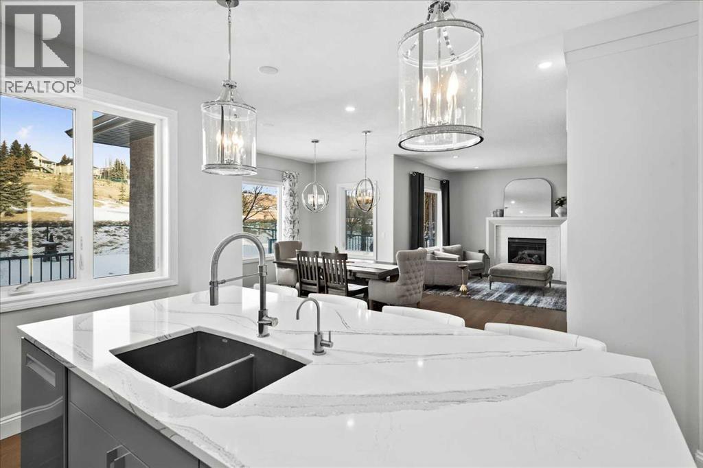 Large quartz island - 255 Gleneagles View, Cochrane, AB - Indoor Photo Showing Kitchen With Double Sink