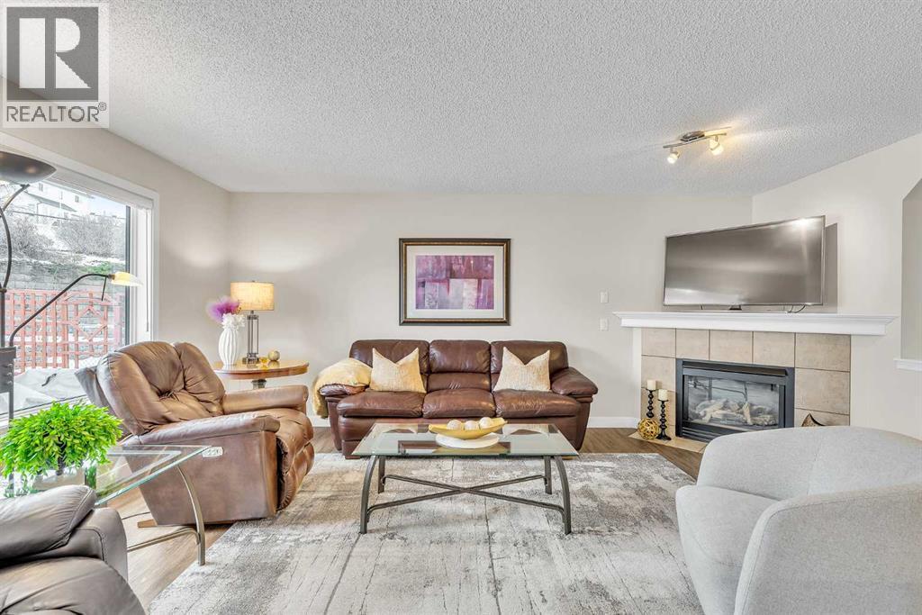 103 Panamount Crescent Nw, Calgary, AB - Indoor Photo Showing Living Room With Fireplace