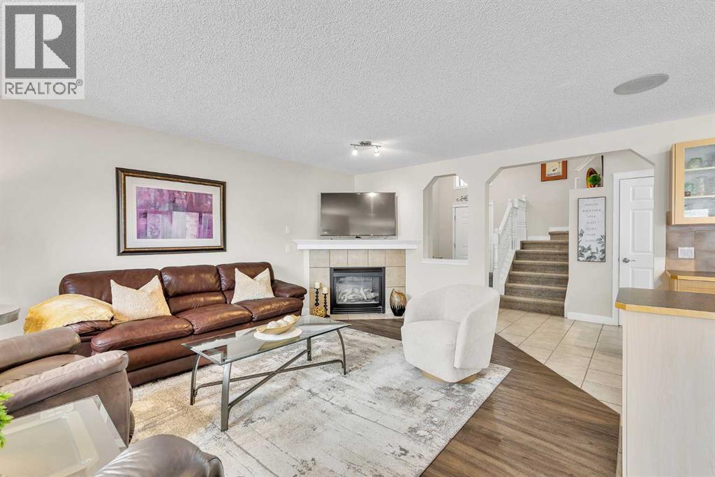 103 Panamount Crescent Nw, Calgary, AB - Indoor Photo Showing Living Room With Fireplace