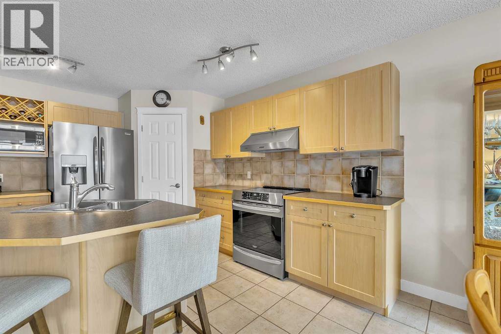 103 Panamount Crescent Nw, Calgary, AB - Indoor Photo Showing Kitchen With Double Sink
