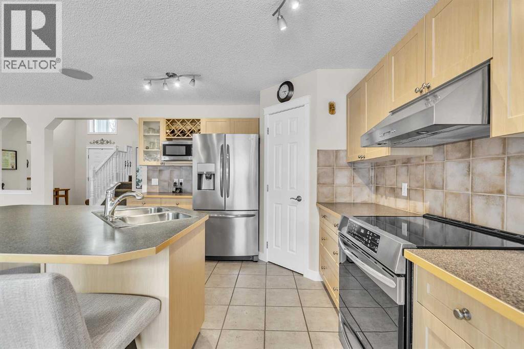103 Panamount Crescent Nw, Calgary, AB - Indoor Photo Showing Kitchen With Double Sink
