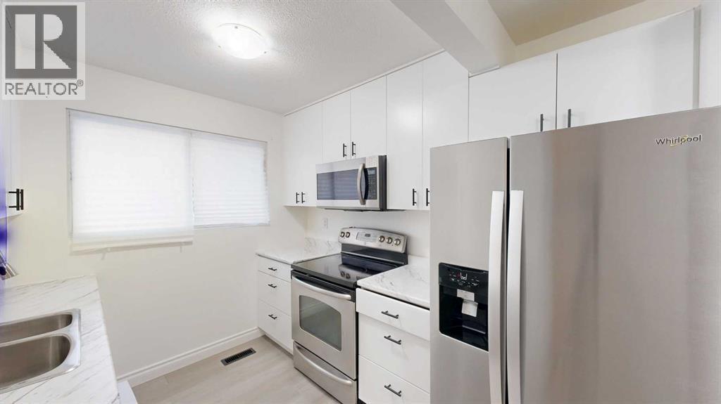 1, 115 Lafayette Boulevard W, Lethbridge, AB - Indoor Photo Showing Kitchen With Double Sink