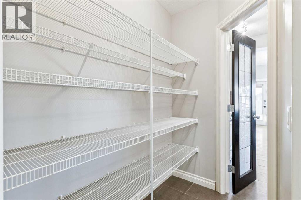 Walk Through Pantry - 110 Heritage Place Ne, Cochrane, AB - Indoor With Storage