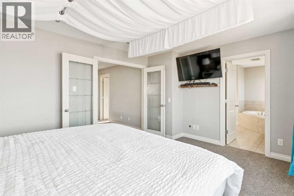 Master Suite #2 - 110 Heritage Place Ne, Cochrane, AB - Indoor Photo Showing Bedroom