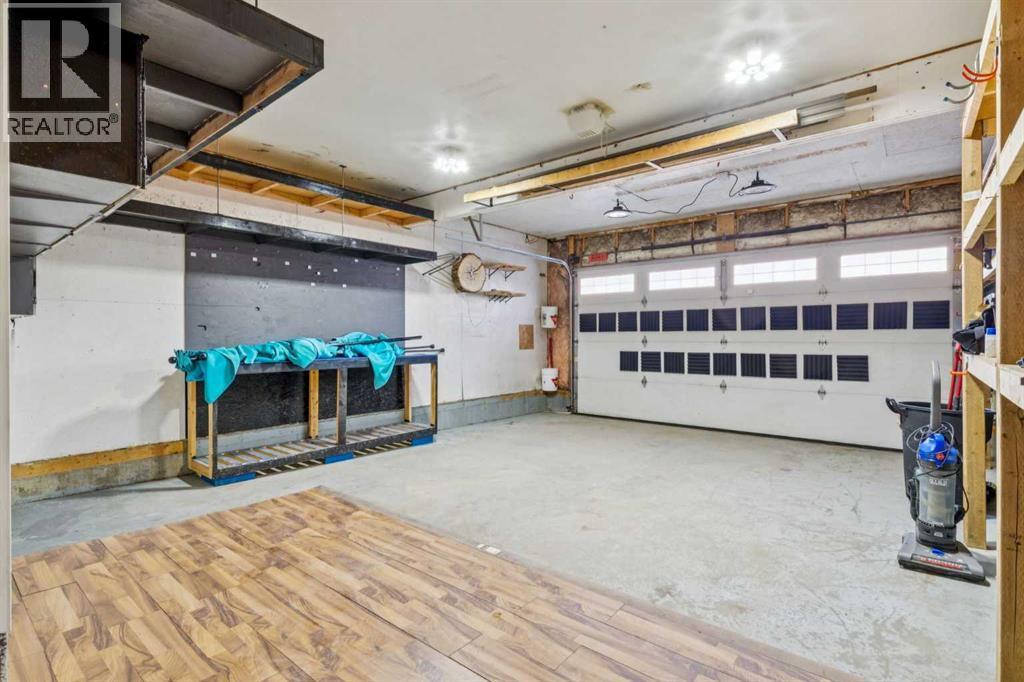 Garage - 110 Heritage Place Ne, Cochrane, AB - Indoor Photo Showing Garage