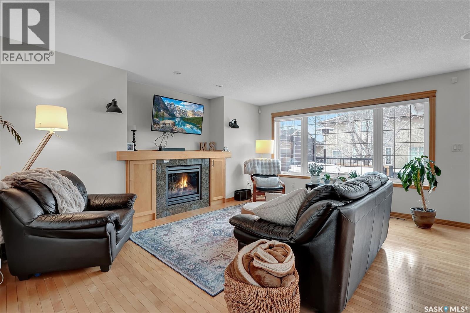 8014 Links Way, Regina, SK - Indoor Photo Showing Living Room With Fireplace