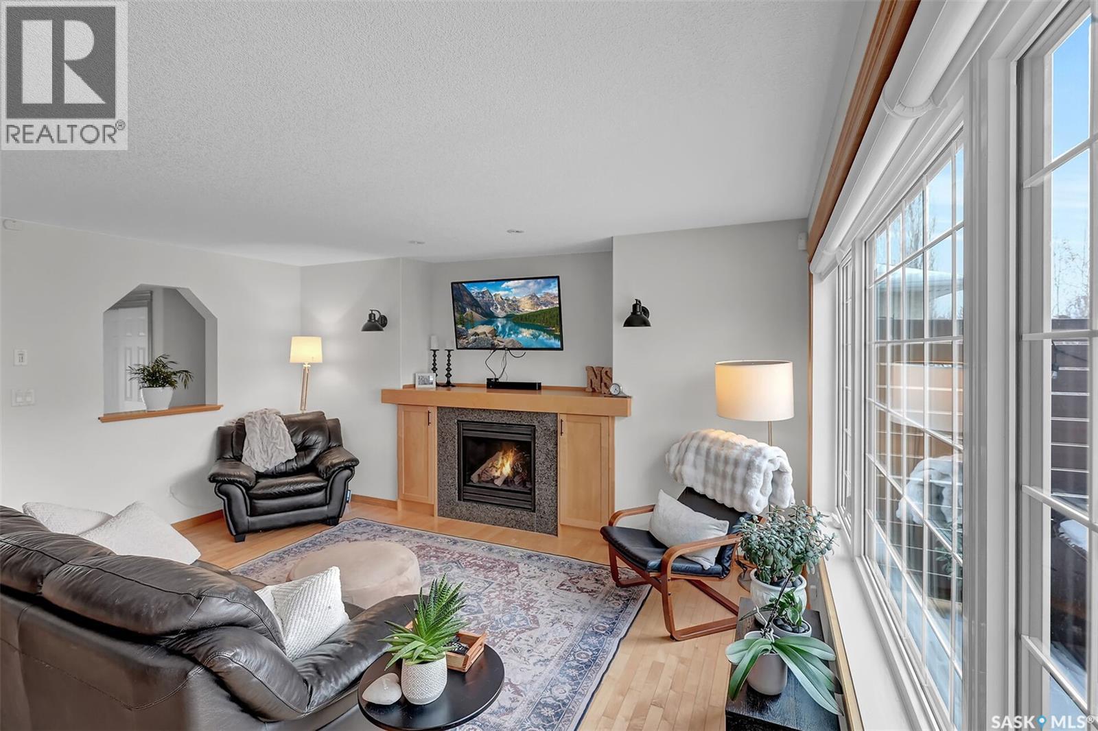 8014 Links Way, Regina, SK - Indoor Photo Showing Living Room With Fireplace