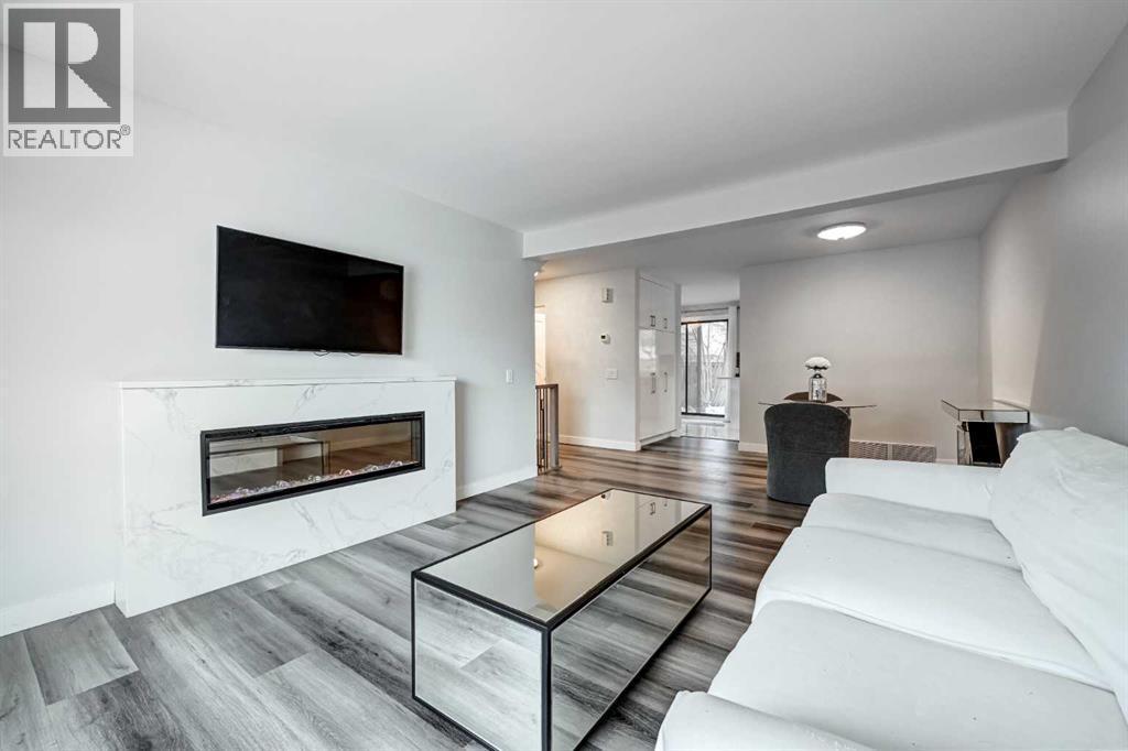 43, 5019 46 Avenue Sw, Calgary, AB - Indoor Photo Showing Living Room With Fireplace