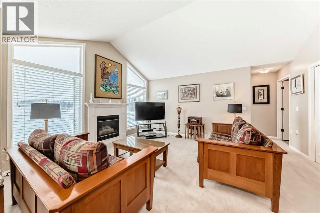 417 Hope Bay, Rural Rocky View County, AB - Indoor Photo Showing Living Room With Fireplace