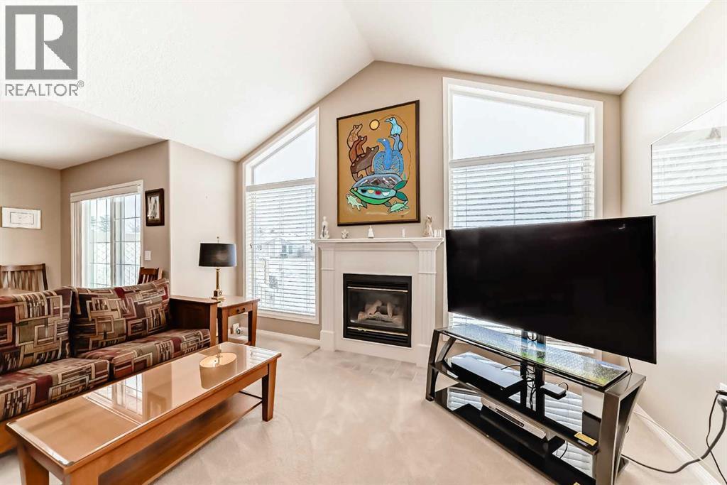 417 Hope Bay, Rural Rocky View County, AB - Indoor Photo Showing Living Room With Fireplace