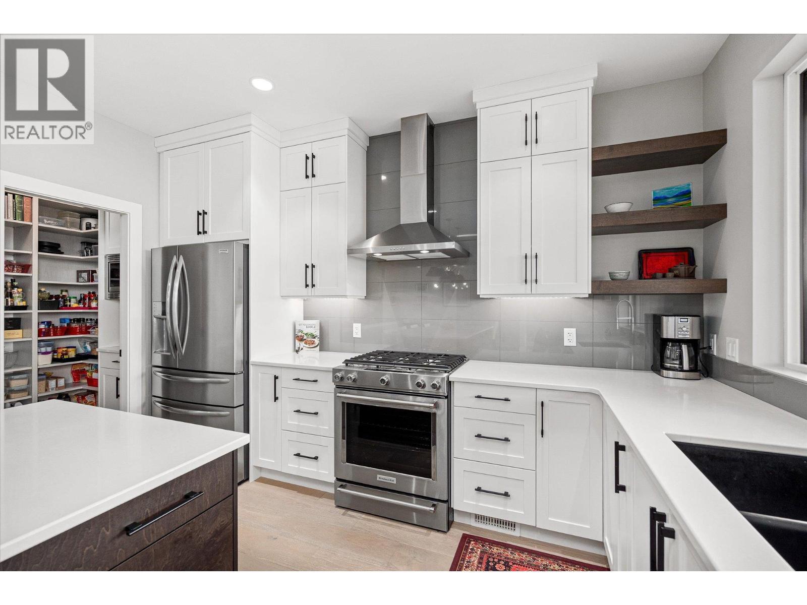 Premium stainless steel appliances (gas range) - 468 Sparrow Hawk Court, Kelowna, BC - Indoor Photo Showing Kitchen With Upgraded Kitchen
