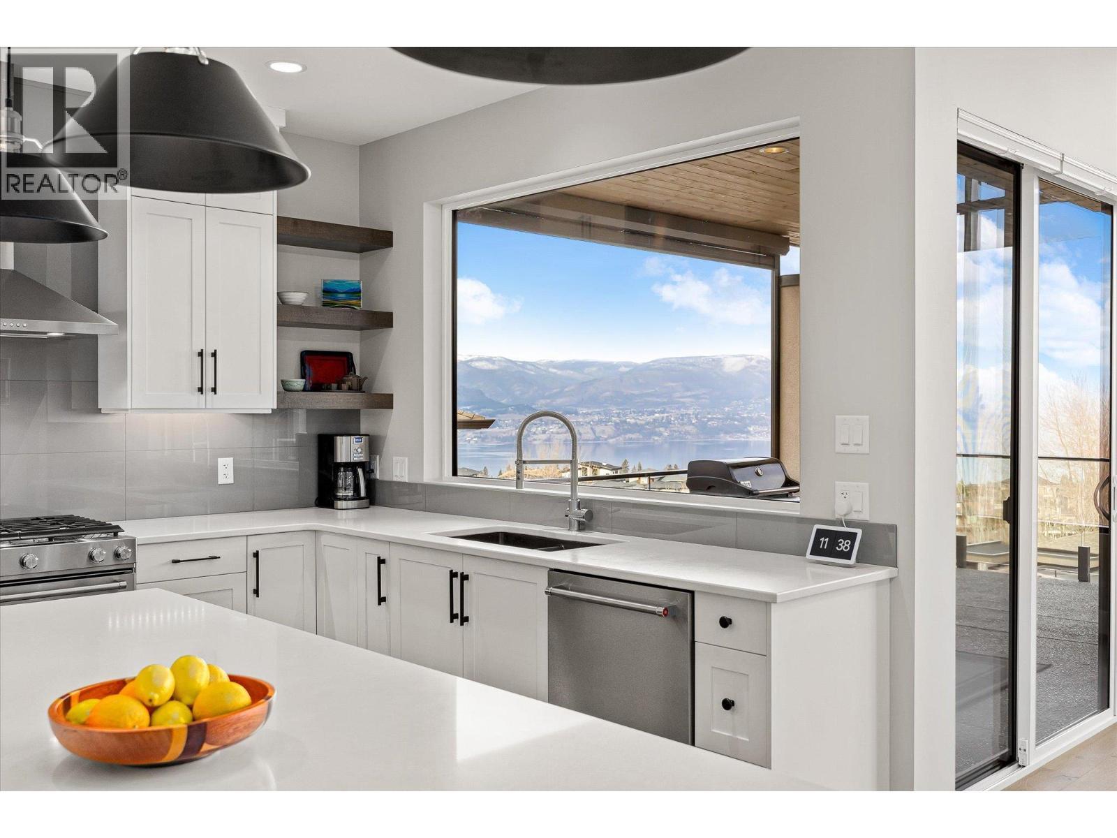 Stunning lake views from the kitchen sink! - 468 Sparrow Hawk Court, Kelowna, BC - Indoor Photo Showing Kitchen With Upgraded Kitchen