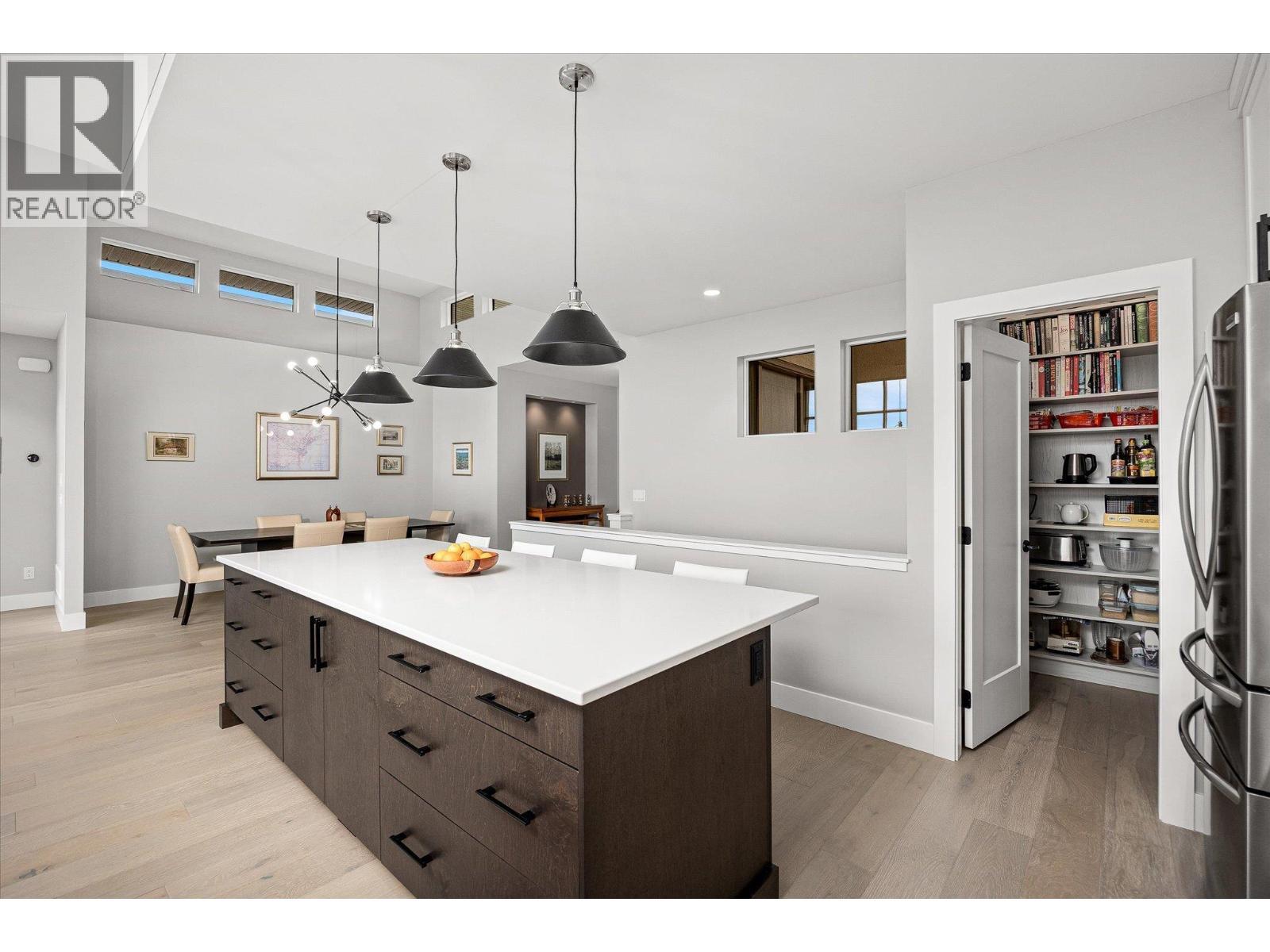Oversized sit-up quartz island - 468 Sparrow Hawk Court, Kelowna, BC - Indoor Photo Showing Kitchen
