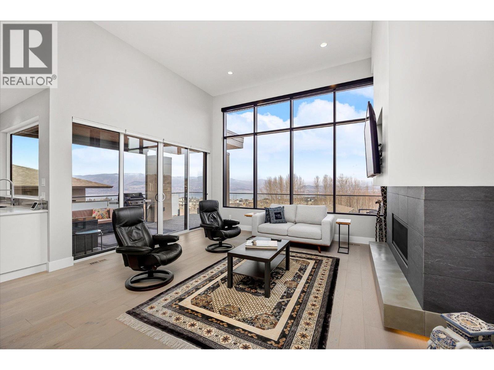 A spacious living area with easy access to the covered lake view patio! - 468 Sparrow Hawk Court, Kelowna, BC - Indoor
