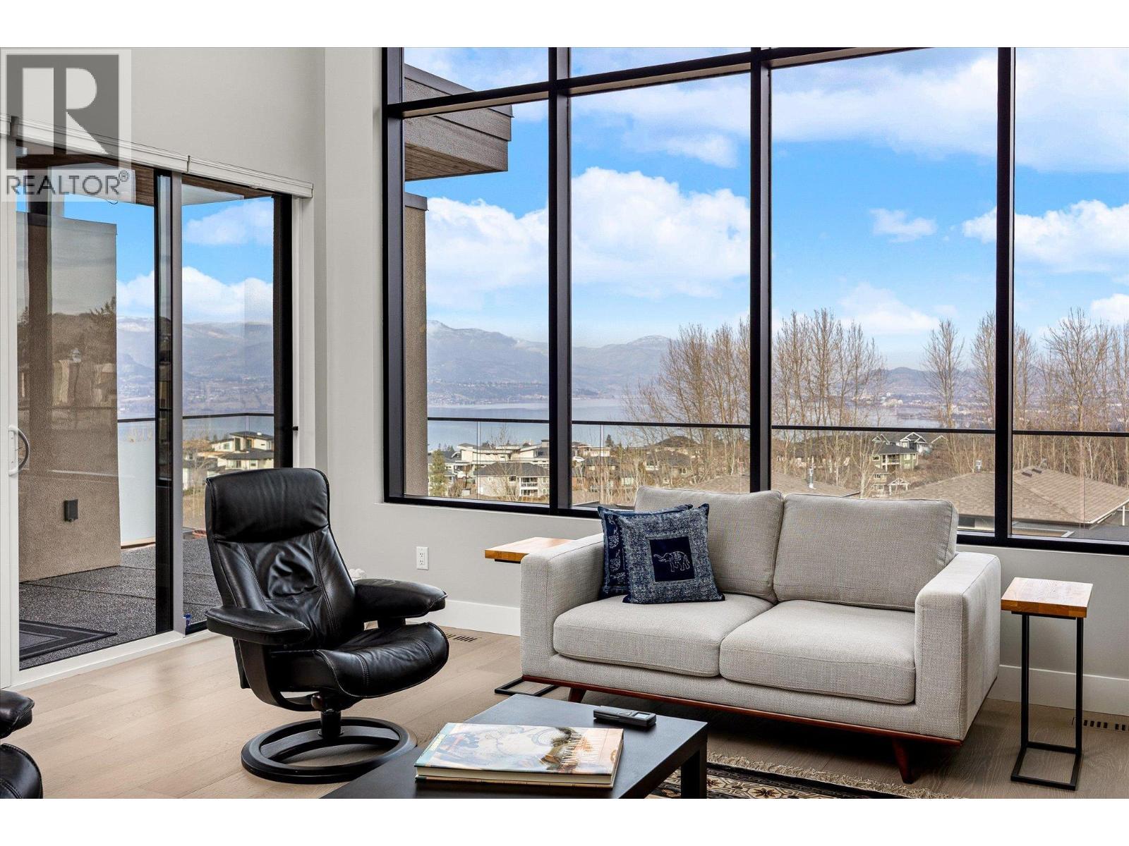 A wall of windows to frame the stunning views...complete with auto blinds! - 468 Sparrow Hawk Court, Kelowna, BC - Photo Showing Other Room