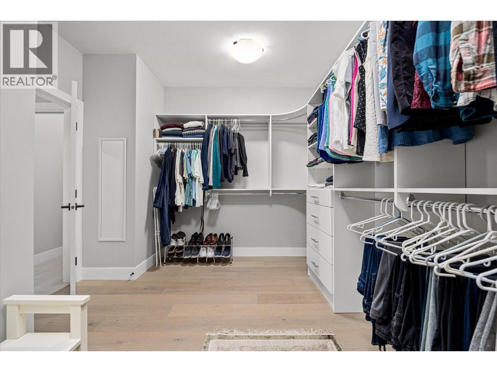 Generous walk-in closet with custom built-ins - 468 Sparrow Hawk Court, Kelowna, BC - Indoor With Storage