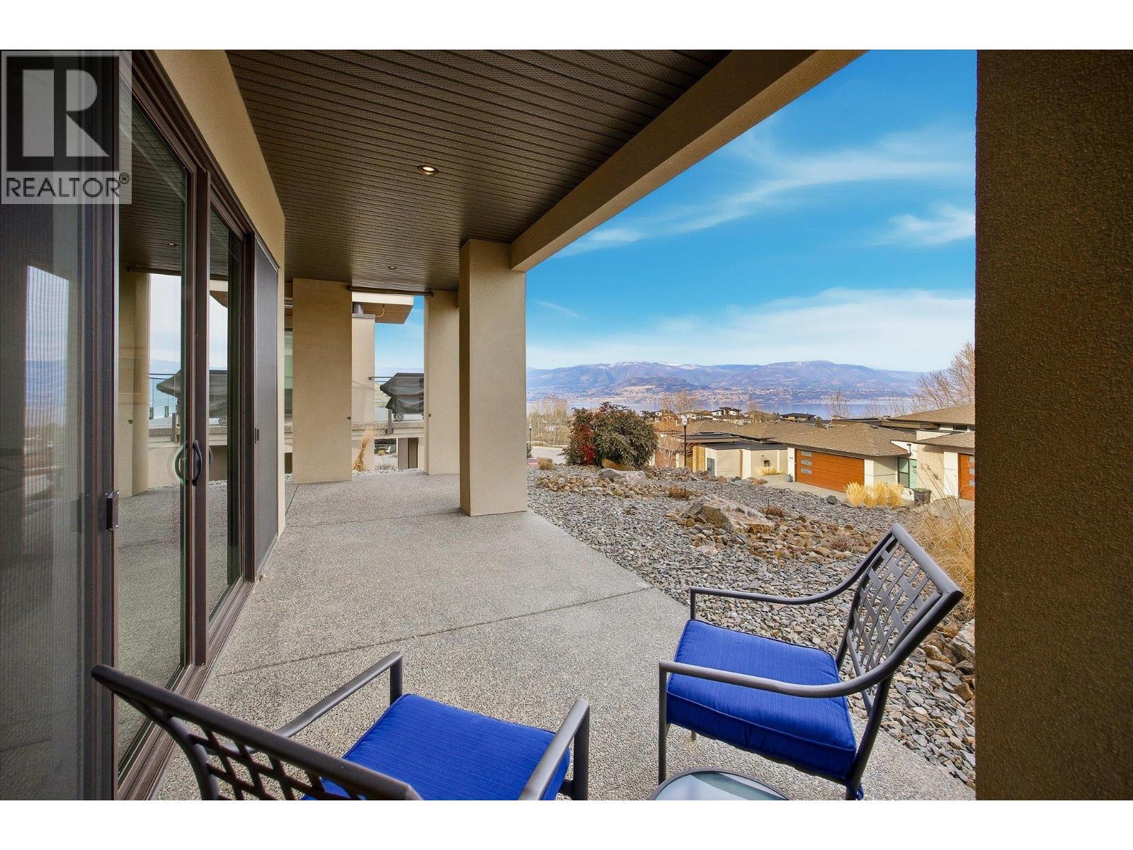 Covered lower-level patio features wood soffits, exposed aggregate - 468 Sparrow Hawk Court, Kelowna, BC - Outdoor With Deck Patio Veranda With Exterior