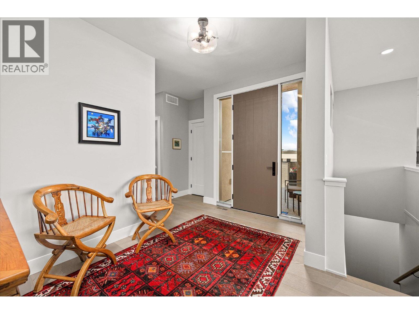 A spacious foyer welcomes you with a coat closet nearby - 468 Sparrow Hawk Court, Kelowna, BC - Indoor Photo Showing Other Room