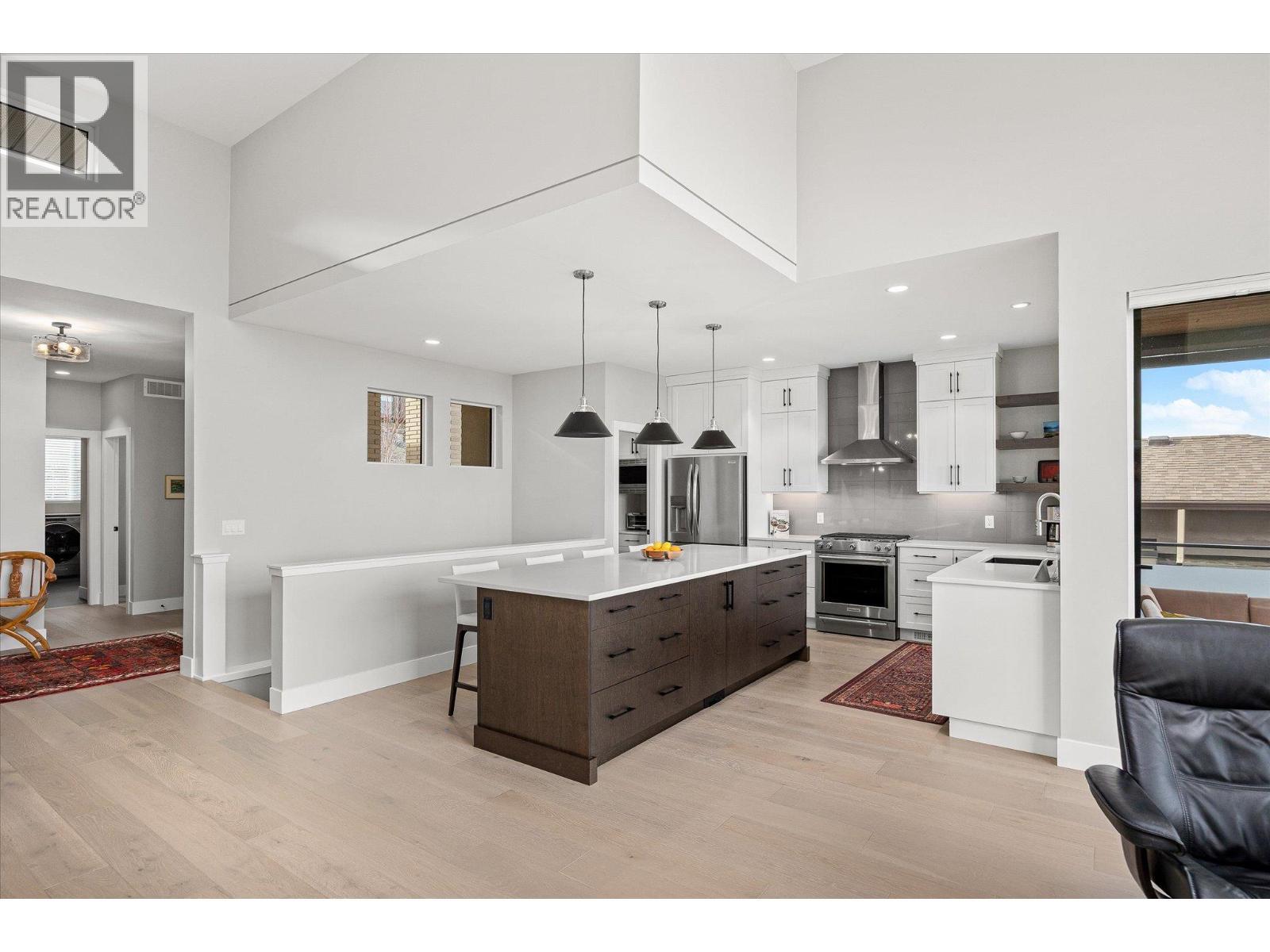 Bright & spacious kitchen with two tone cabinetry & lovely pendant lighting - 468 Sparrow Hawk Court, Kelowna, BC - Indoor Photo Showing Kitchen