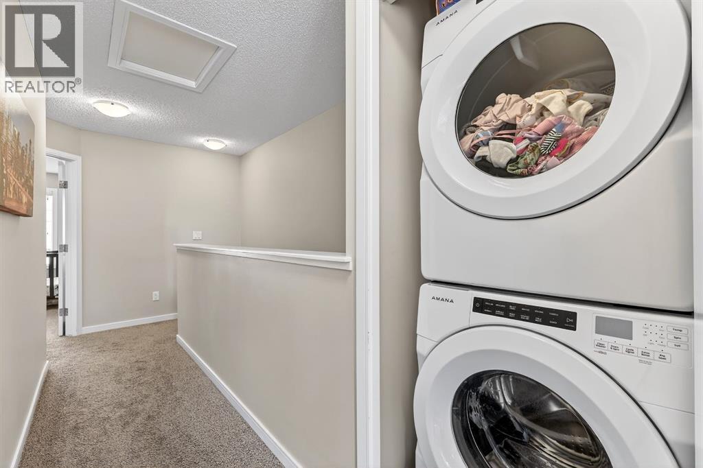 Convenient upper laundry - 330 Marquis Lane Se, Calgary, AB - Indoor Photo Showing Laundry Room