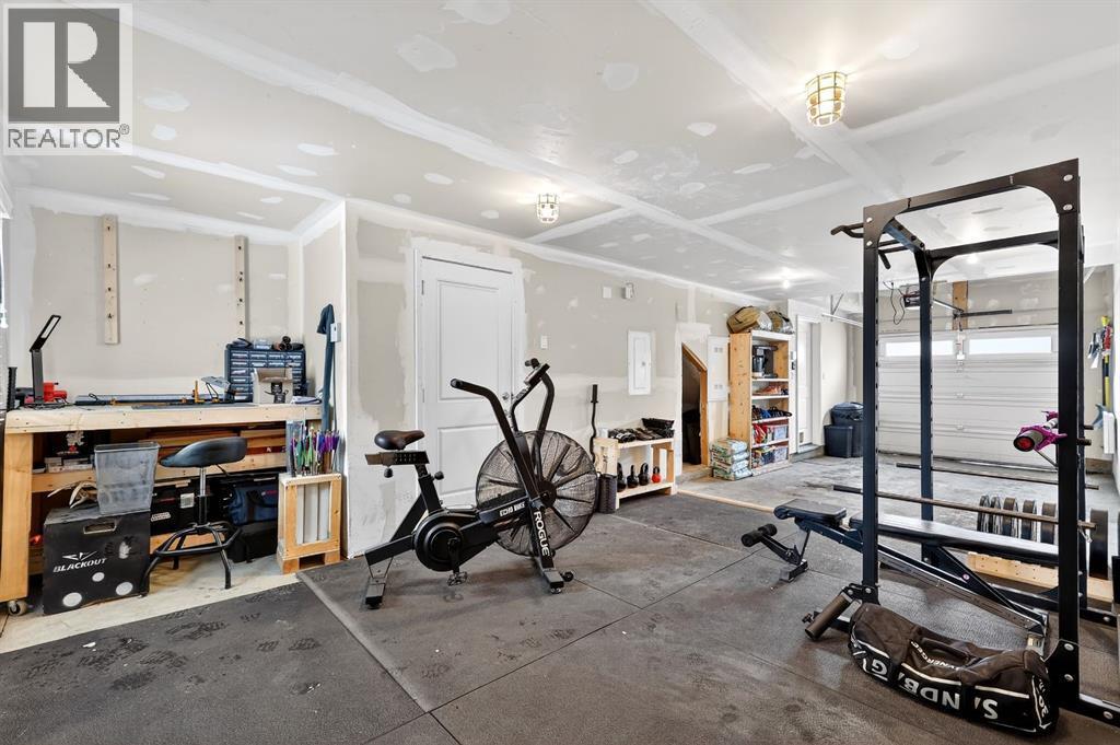 Park 2 vehicles/home gym/storage - 330 Marquis Lane Se, Calgary, AB - Indoor Photo Showing Gym Room