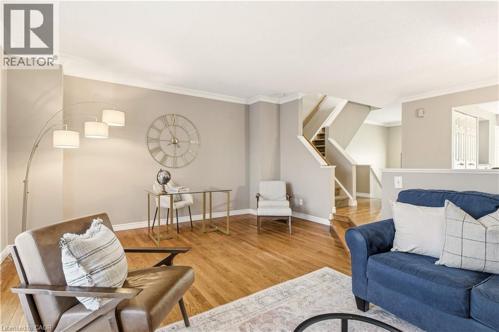 Living room featuring stairs, crown molding, and light wood-style flooring - 1489 Litchfield Road, Oakville, ON - Indoor Photo Showing Living Room
