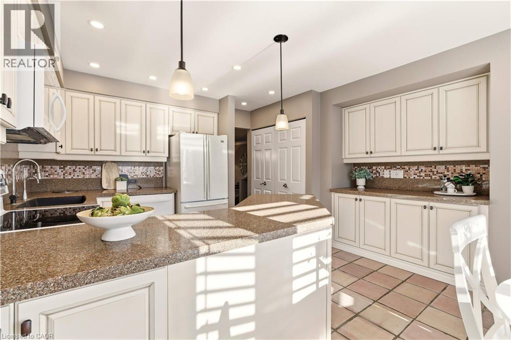 Kitchen featuring backsplash, hanging light fixtures, white appliances, white cabinetry, and recessed lighting - 1489 Litchfield Road, Oakville, ON - Indoor Photo Showing Kitchen With Upgraded Kitchen