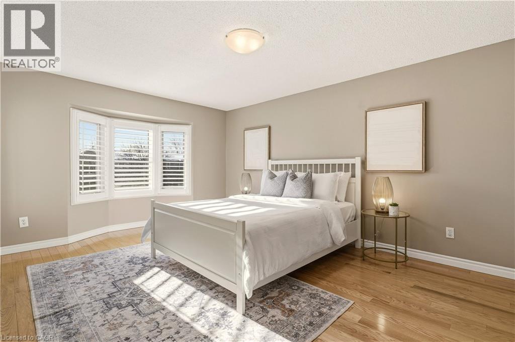 Bedroom with light wood-type flooring and a textured ceiling - 1489 Litchfield Road, Oakville, ON - Indoor Photo Showing Bedroom