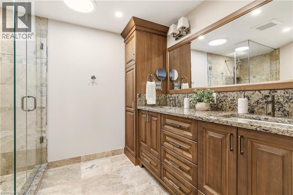 Full bathroom with double vanity, tasteful backsplash, a stall shower, and light stone finish floors - 1489 Litchfield Road, Oakville, ON - Indoor Photo Showing Bathroom