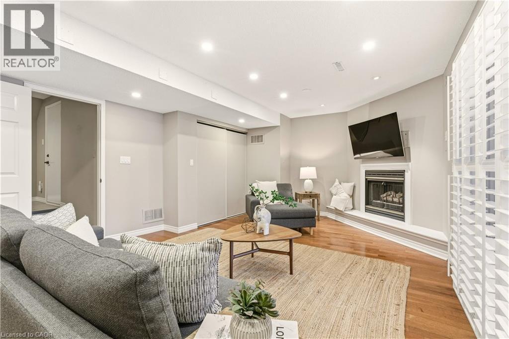 Living area with a glass covered fireplace, light wood-style floors, and recessed lighting - 1489 Litchfield Road, Oakville, ON - Indoor Photo Showing Living Room With Fireplace