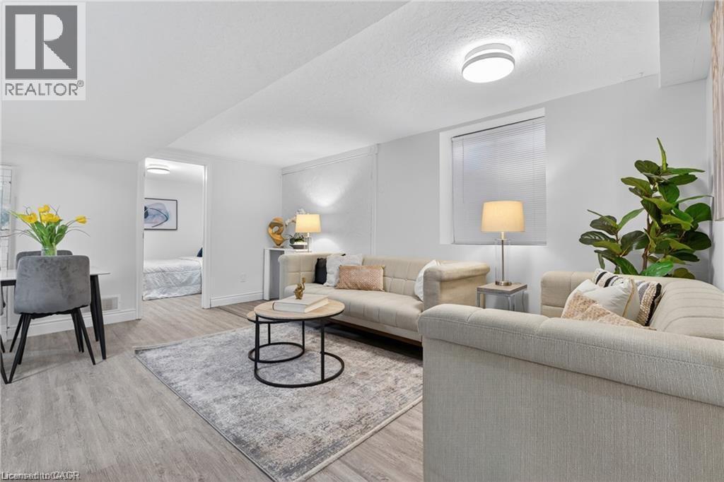 Living area featuring light wood-style floors and a textured ceiling - 146 Appalachian Crescent Unit# Lower, Kitchener, ON - Indoor Photo Showing Living Room