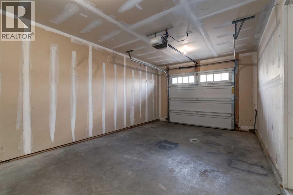 705 Evanston Square Nw, Calgary, AB - Indoor Photo Showing Garage