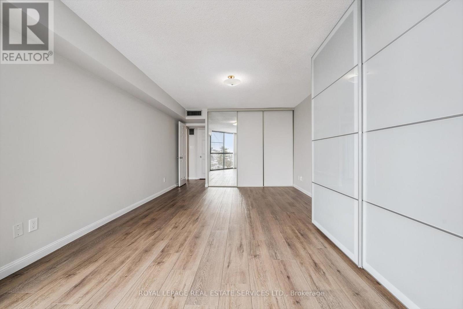 Spacious Bedroom w/New Engineered Hardwood Floor - 702 - 1240 Marlborough Court, Oakville, ON - Indoor Photo Showing Other Room