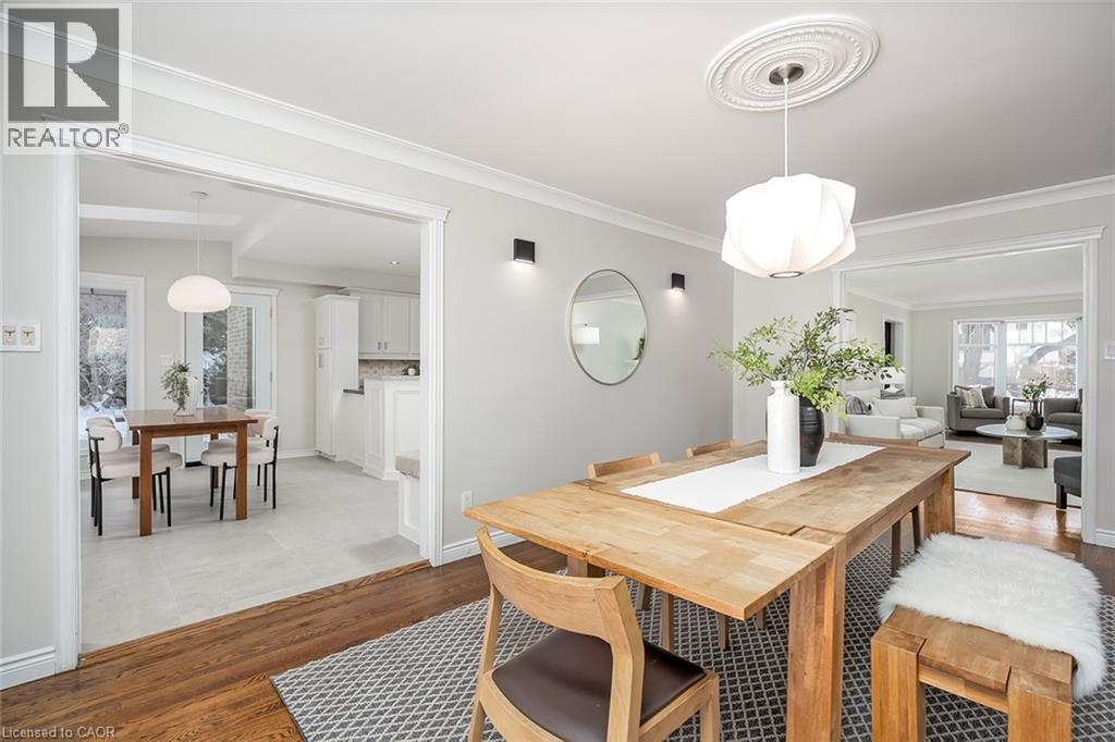 Dining space with light wood-style flooring and ornamental molding - 4226 Dunvegan Road, Burlington, ON - Indoor Photo Showing Dining Room