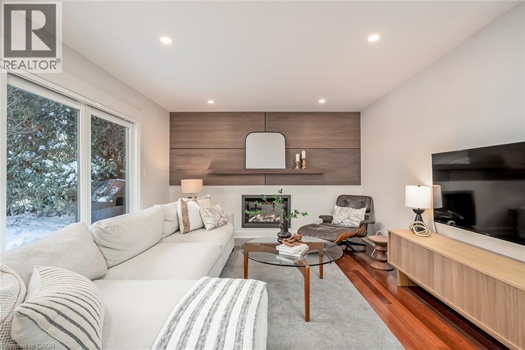 Living room with wood finished floors, recessed lighting, and a large fireplace - 4226 Dunvegan Road, Burlington, ON - Indoor Photo Showing Living Room