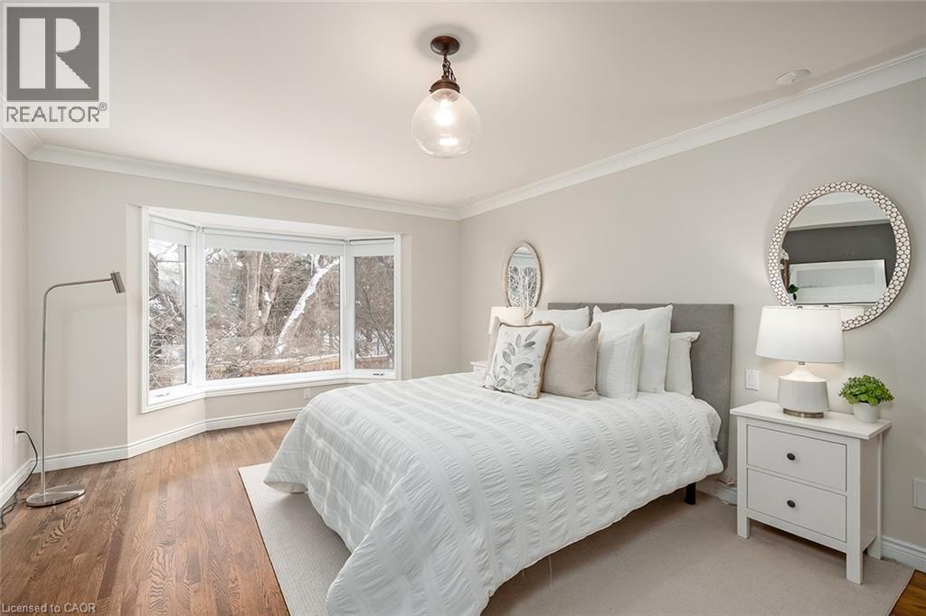 Bedroom with crown molding and wood finished floors - 4226 Dunvegan Road, Burlington, ON - Indoor Photo Showing Bedroom