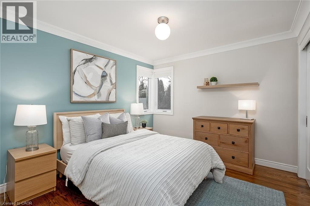 Bedroom with dark wood-type flooring and crown molding - 4226 Dunvegan Road, Burlington, ON - Indoor Photo Showing Bedroom