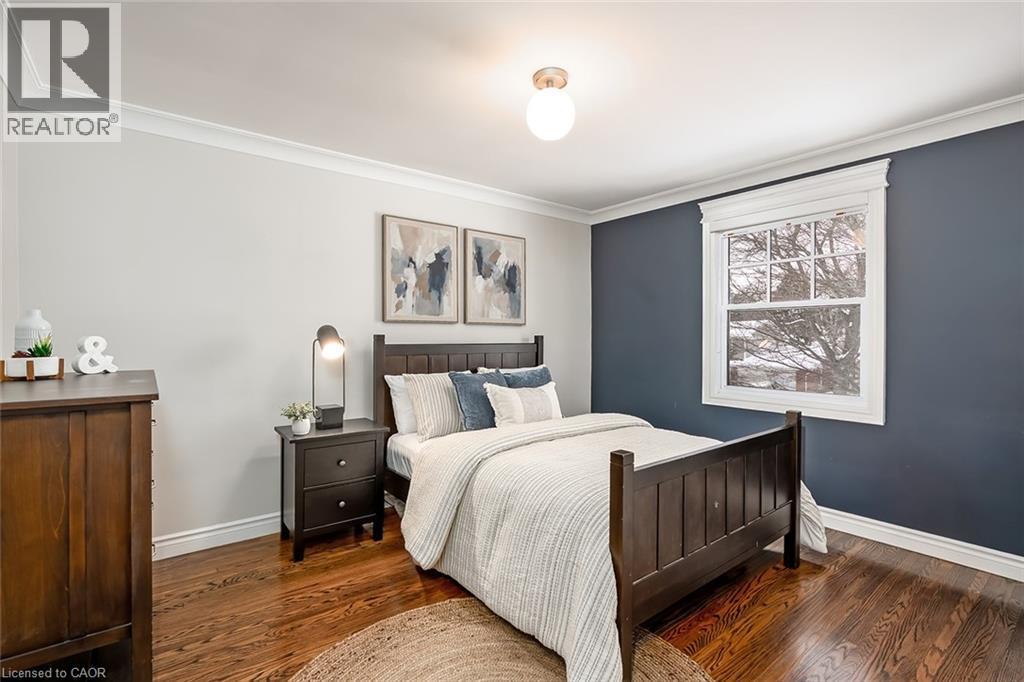 Bedroom featuring crown molding and dark wood-style flooring - 4226 Dunvegan Road, Burlington, ON - Indoor Photo Showing Bedroom